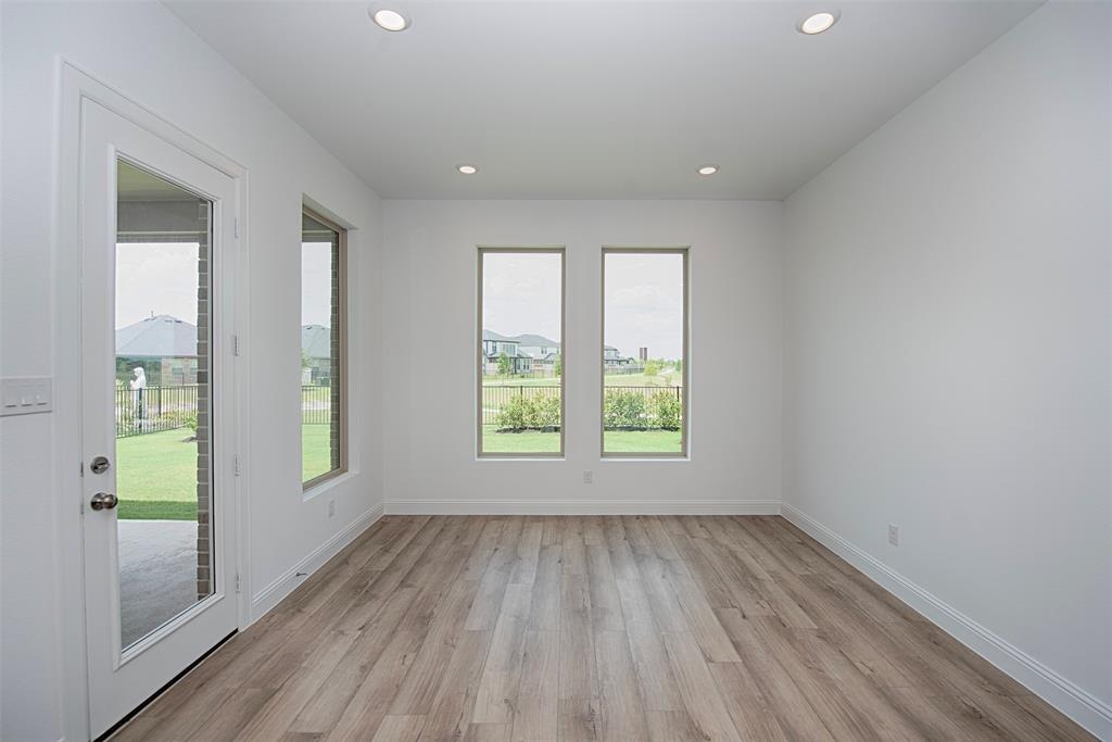 End of the kitchen is a spacious dining area with large windows and views of the backyard, the patio and even the lake.