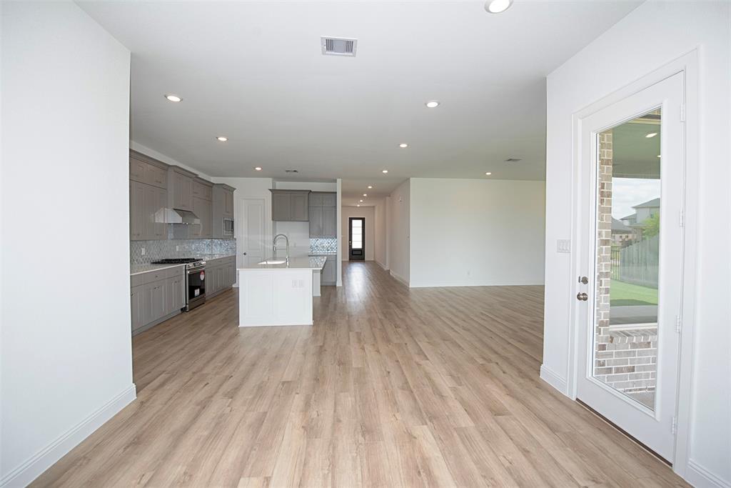 A view of the dining area with ease of access to the kitchen. It\'s even open all the way to the foyer.