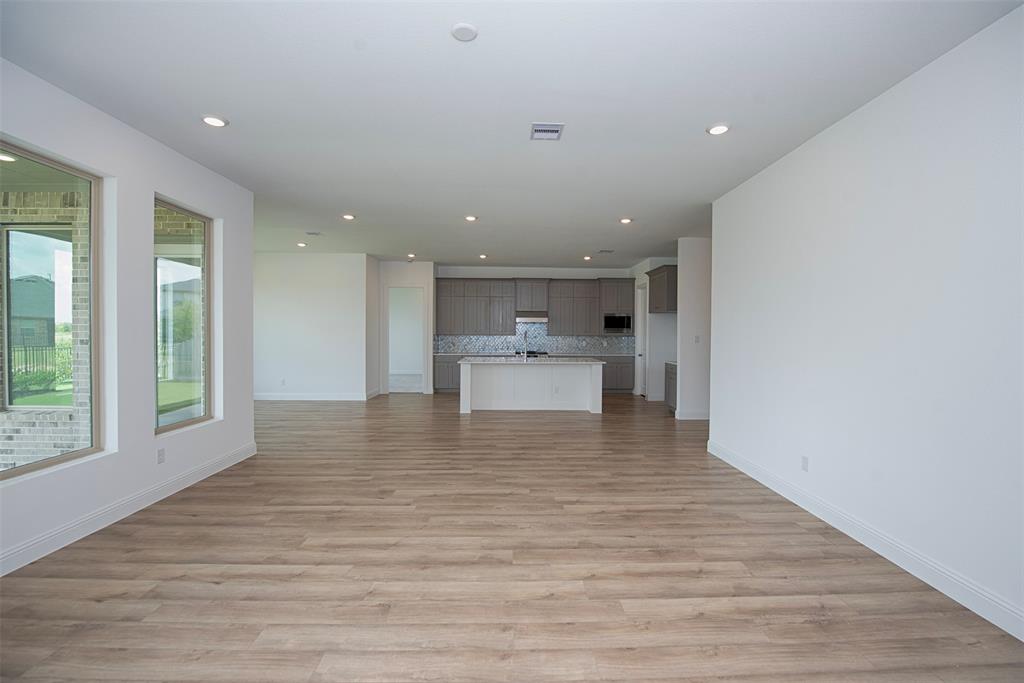 A view of the wonderfully spacious family room open to the kitchen. This open floor plan is perfection for those who love to entertain.