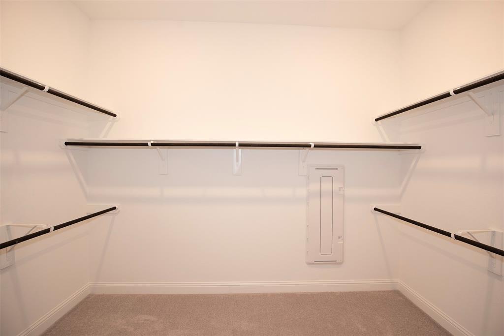 Huge walk in closet with plenty of space for sharing.