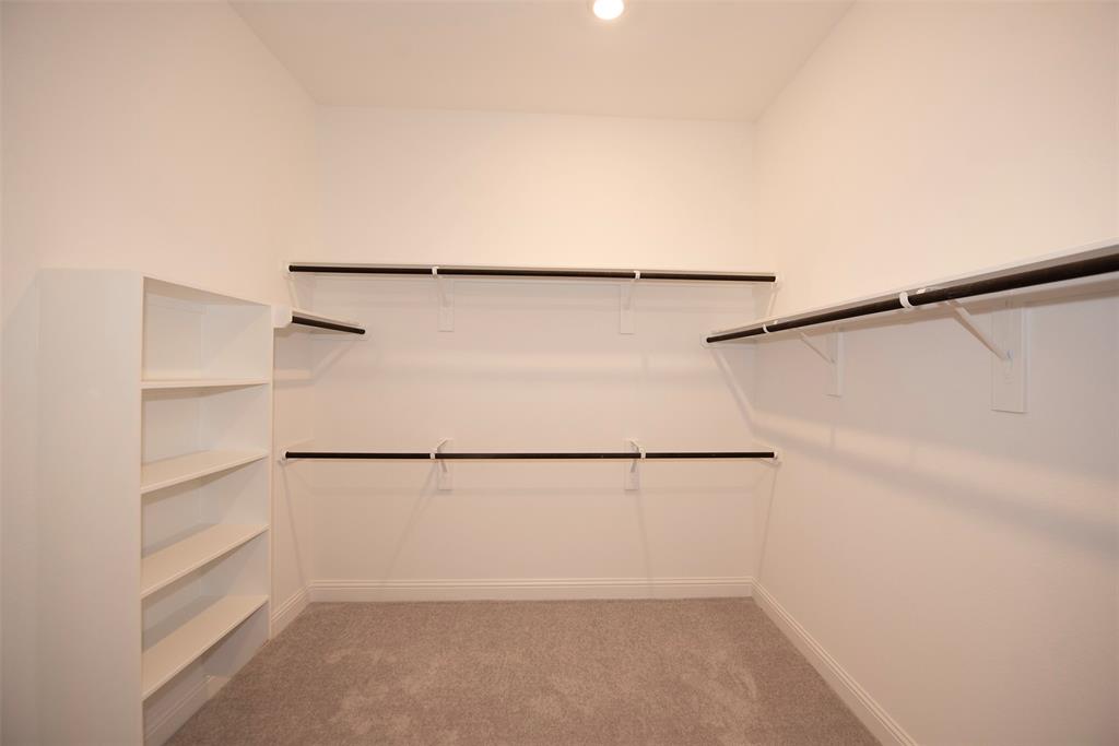 Closet also provides built in shelving. Perfect for shoes or handbags.