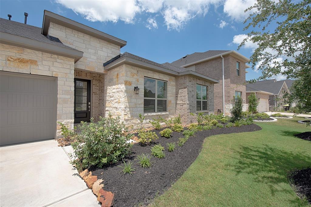 Stunning landscaping with stone accents as you approach the front porch. Wonderfully inviting for your guests when entertaining. Gorgeous curb appeal.