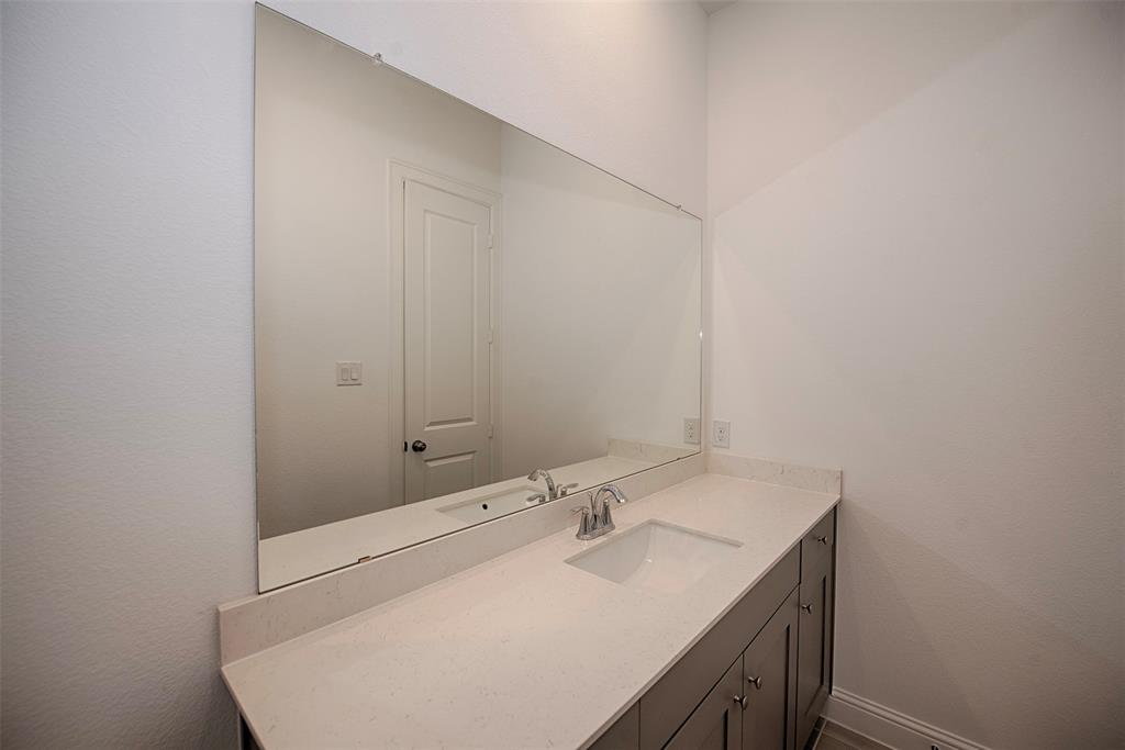 Another view of the large vanity and storage below. This bathroom is perfect for sharing.