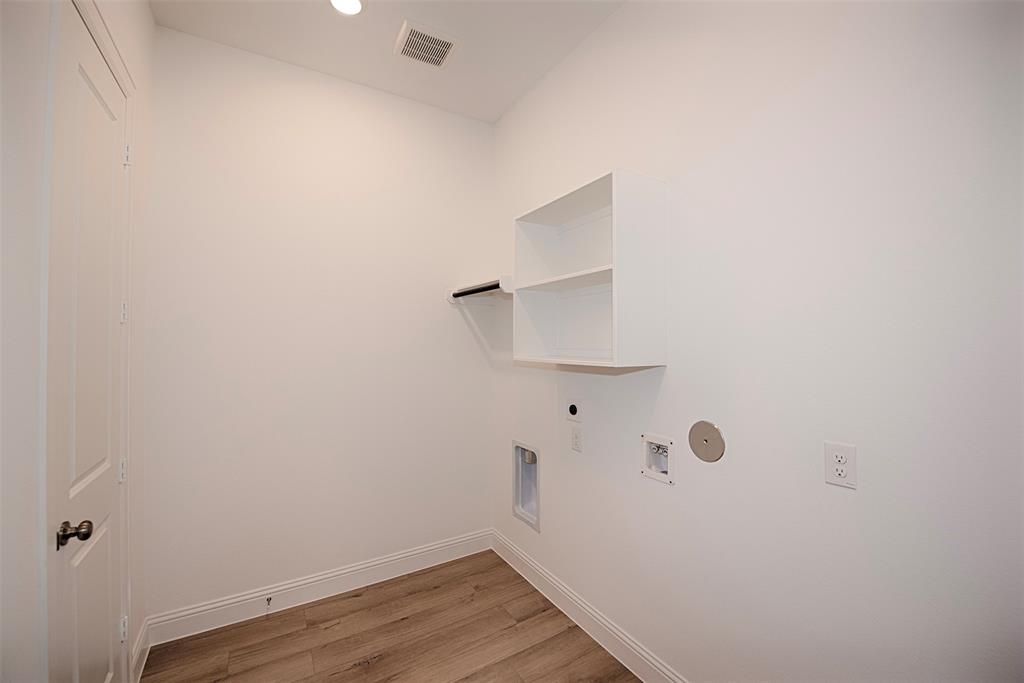 Utility room with fantastic space. Built in storage for your laundry essentials, a rod for hanging clothes and even room for a secondary refrigerator.