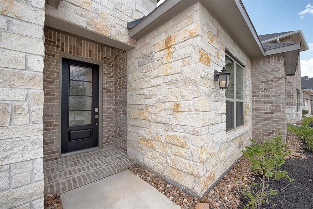 Home has stunning limestone accents and contemporary and gorgeous front door.