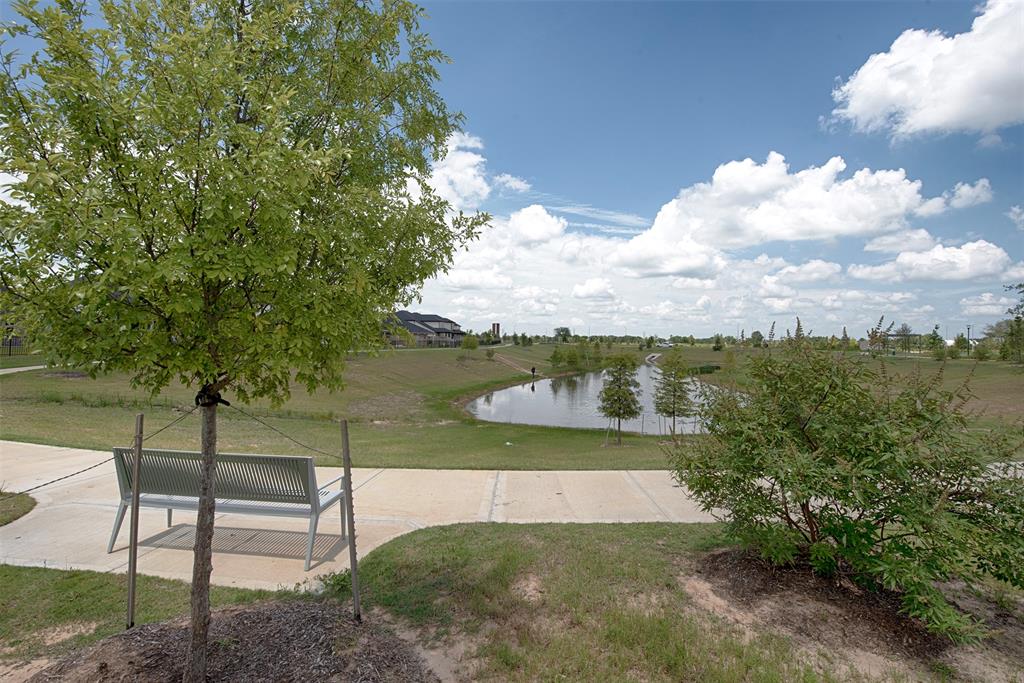 A view from the backyard of the gorgeous lake which is surrounded by a walk way. Perfect for an evening walk with the family dog or perhaps a morning jog.