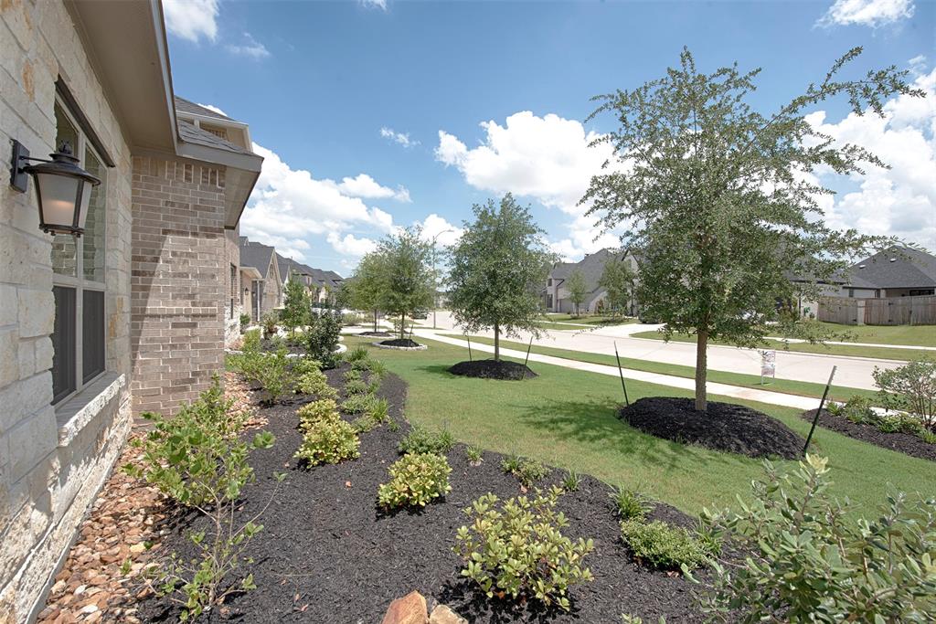 A view of the lush landscaping and view of this wonderful quiet neighborhood.