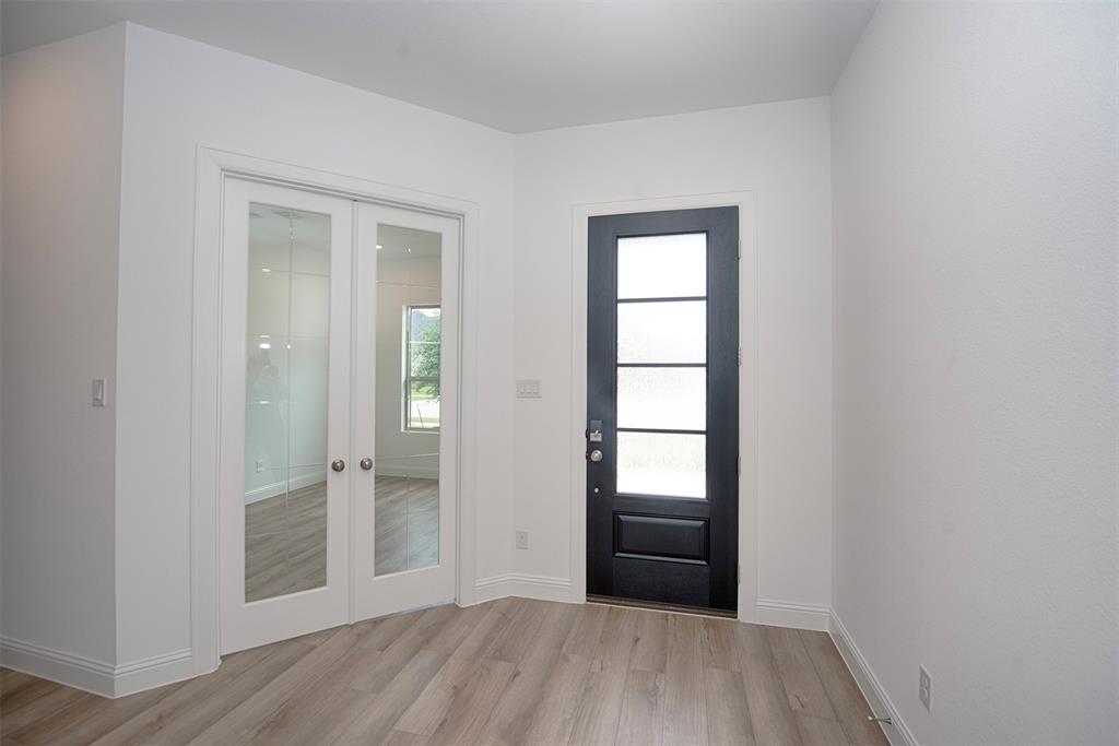 Foyer entry showing the gorgeous door as well as French doors to the home office.