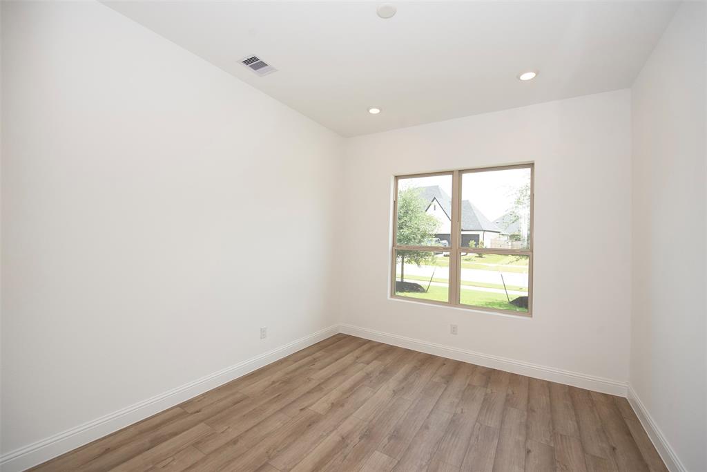 Home office features amazing space, gorgeous luxury vinyl floors and great views of the front yard.