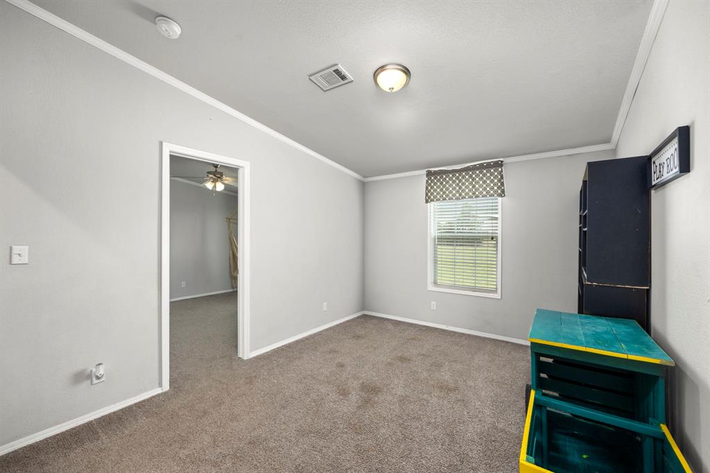 Bedroom 2 just off the flex room with a walk in closet. Windows face the front of the house