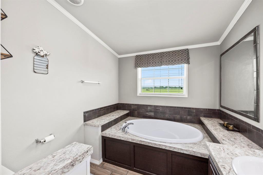 dual sinks with plenty of countertop space and built in linen cabinet