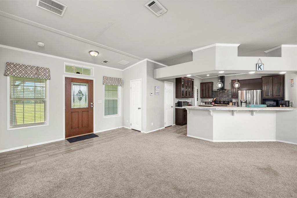 view from entry area into the living room, kitchen and dining room.