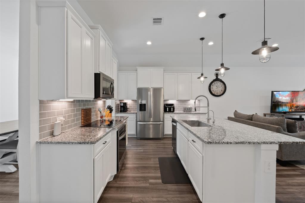 Kitchen is open to the living room, with dining room just behind it