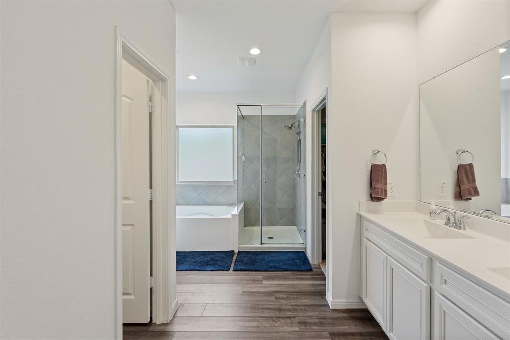 Primary Bathroom with double sinks, separate shower and tub. Primary closet located off the bathroom.