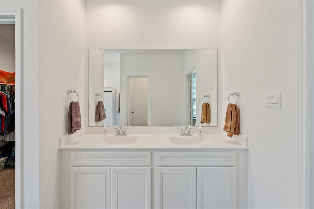 Primary Bathroom with double sinks, separate shower and tub. Primary closet located off the bathroom.