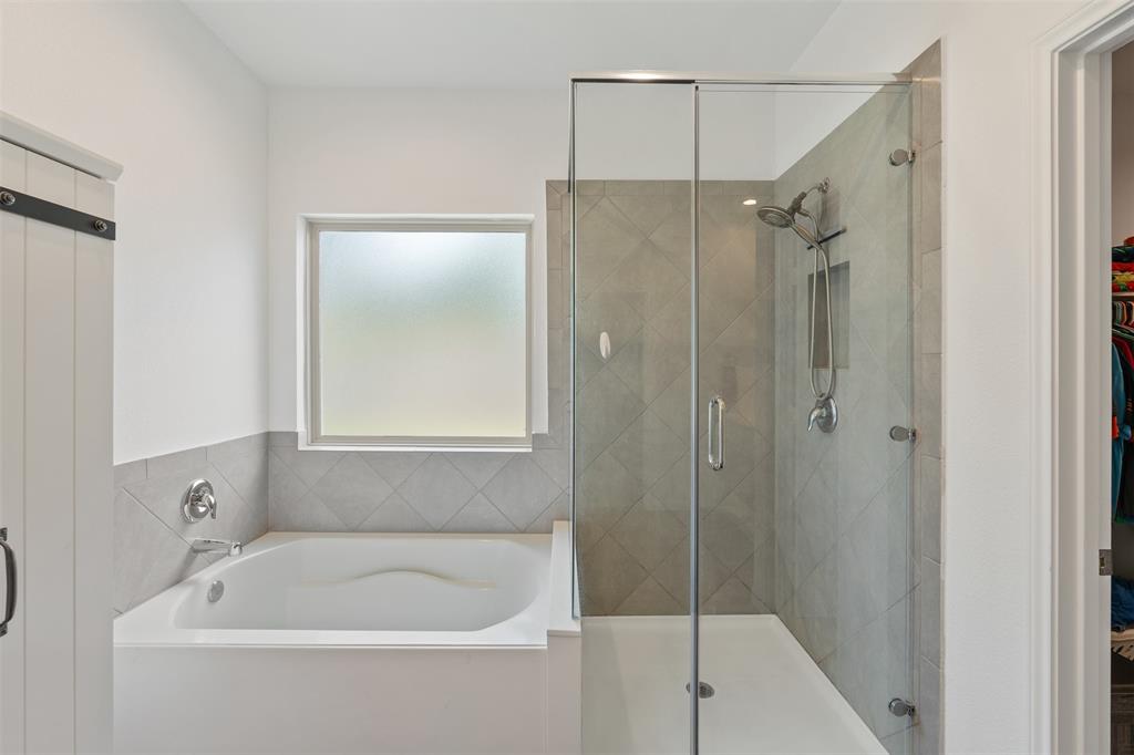 Primary Bathroom with double sinks, separate shower and tub. Primary closet located off the bathroom.