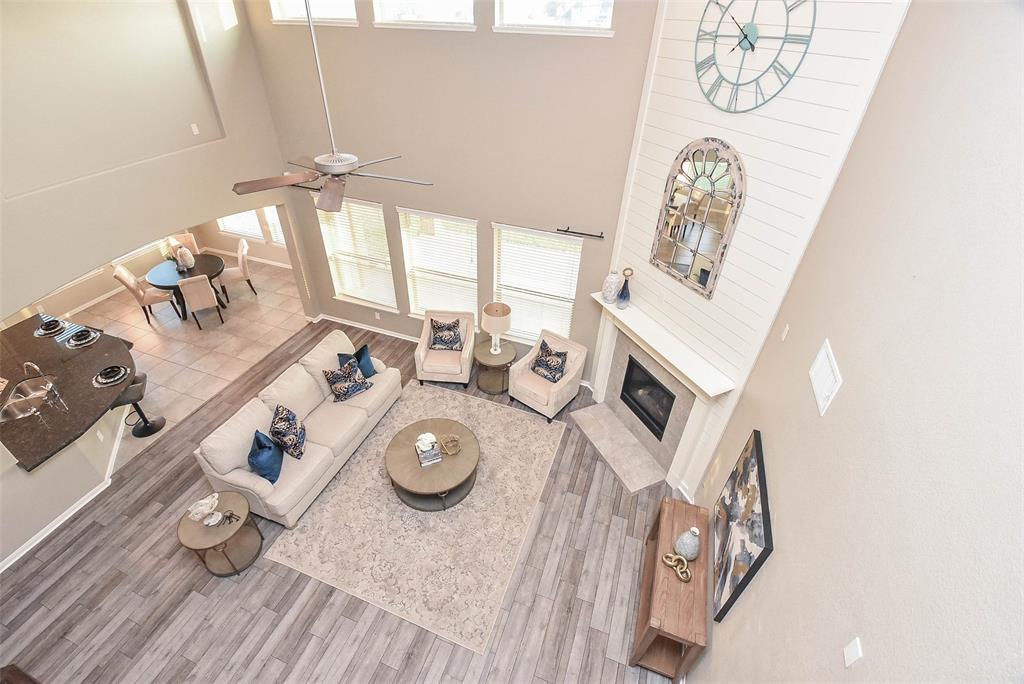 This marvelous wood/wrought iron staircase is a work of art, in itself; with lush space (left) in the stunning living area, left.