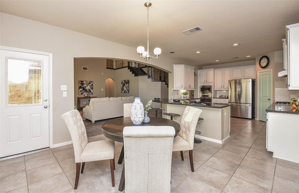 The versatility and beauty of the open floor plan design concept is, once again, clearly appreciated in this view of kitchen counter space/breakfast nook, easily linking to living space/common areas, beyond.