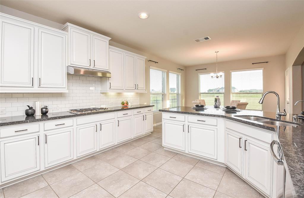 What a lovely view from the bright breakfast nook into the kitchen, proper; living space and gorgeous placement of the staircase.