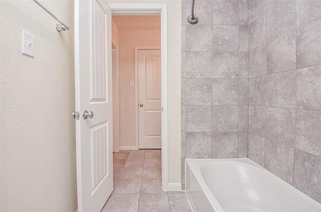 The soothing earth toned tile in this combined bathtub/shower will relax to the max!