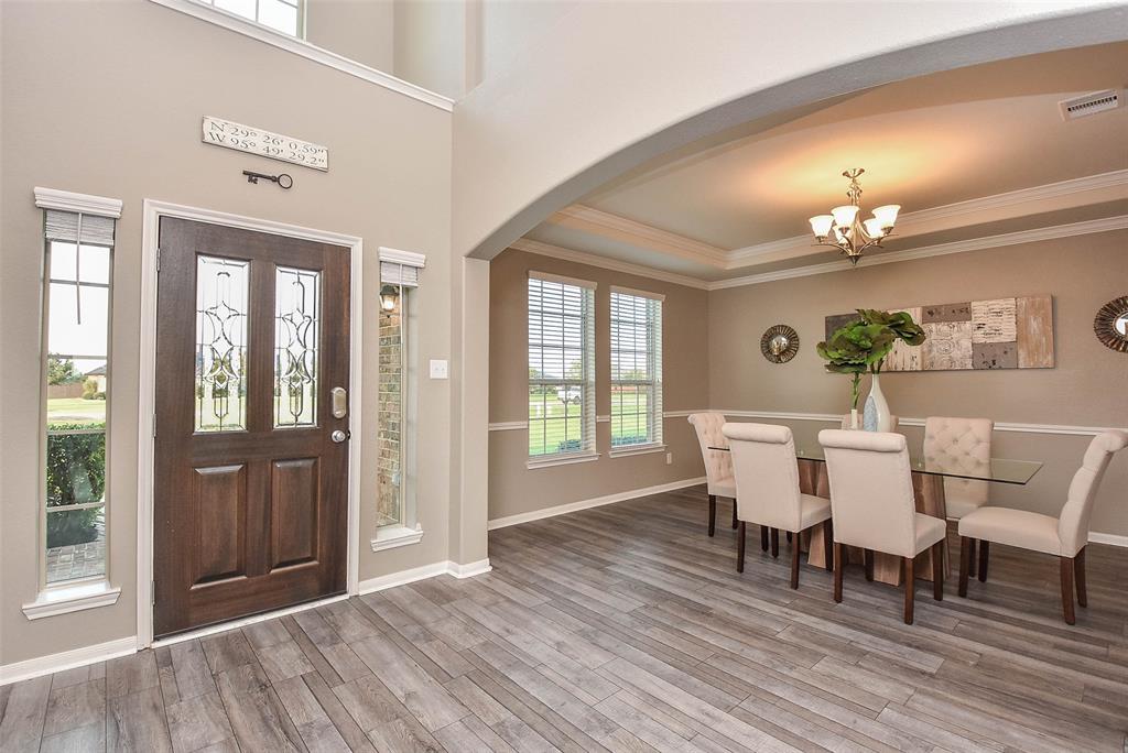 This generous brick/stone-lined front porch includes its lovely, covered front entrance.