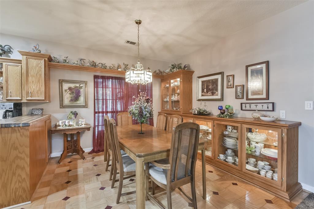 Dining Room with red oak cabinetry and interior display lights.