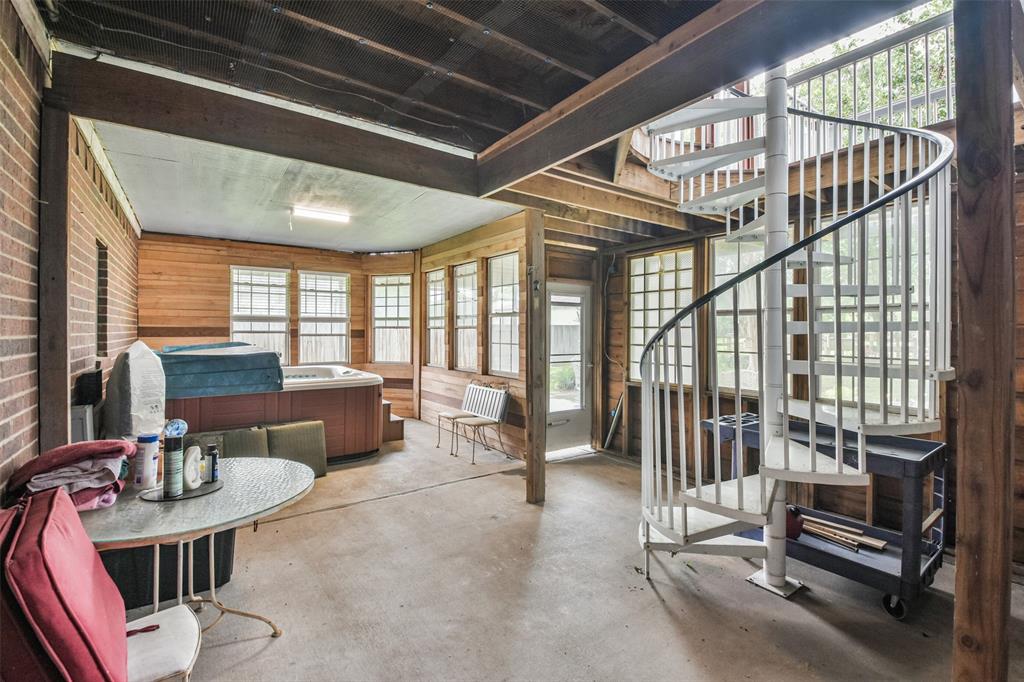 Enclosed Spa room with spiral staircase leading to 2nd floor patio