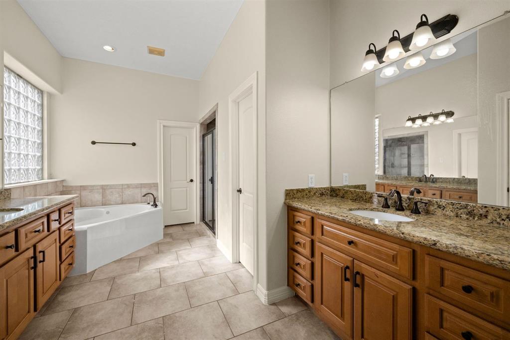 Primary Bath with Duel Vanities, many drawers and cabinet space.