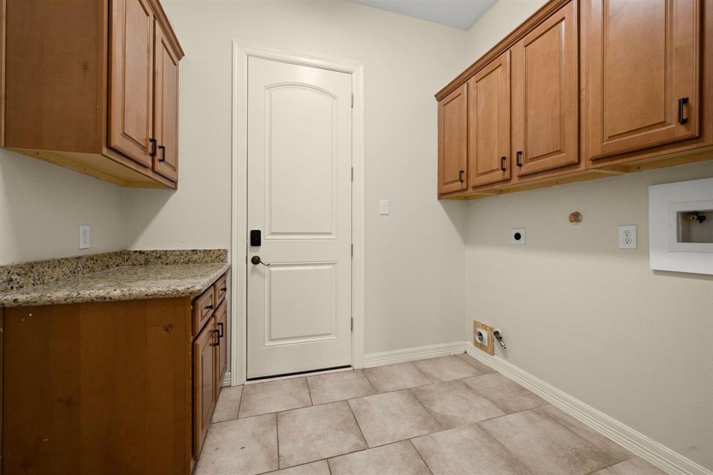 Great Laundry Room with a lot of cabinets for detergents and such.  Long counter is great as a folding table!