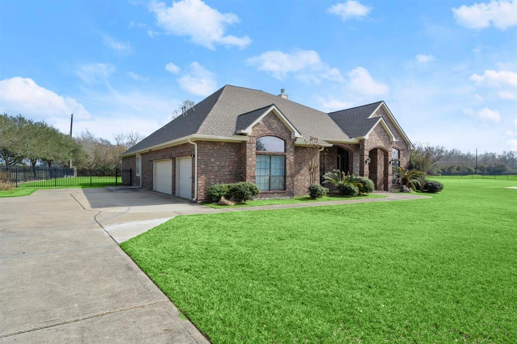 View of front with alot of land and side view with 3 car garage!