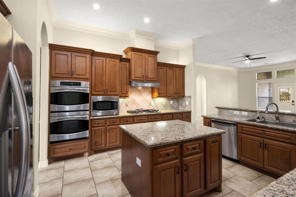 Spacious kitchen with double oven and microwave!  Island has extra drawers and cabinets with slide in trash bin.  Under cabinet lighting on both sides of the kitchen.