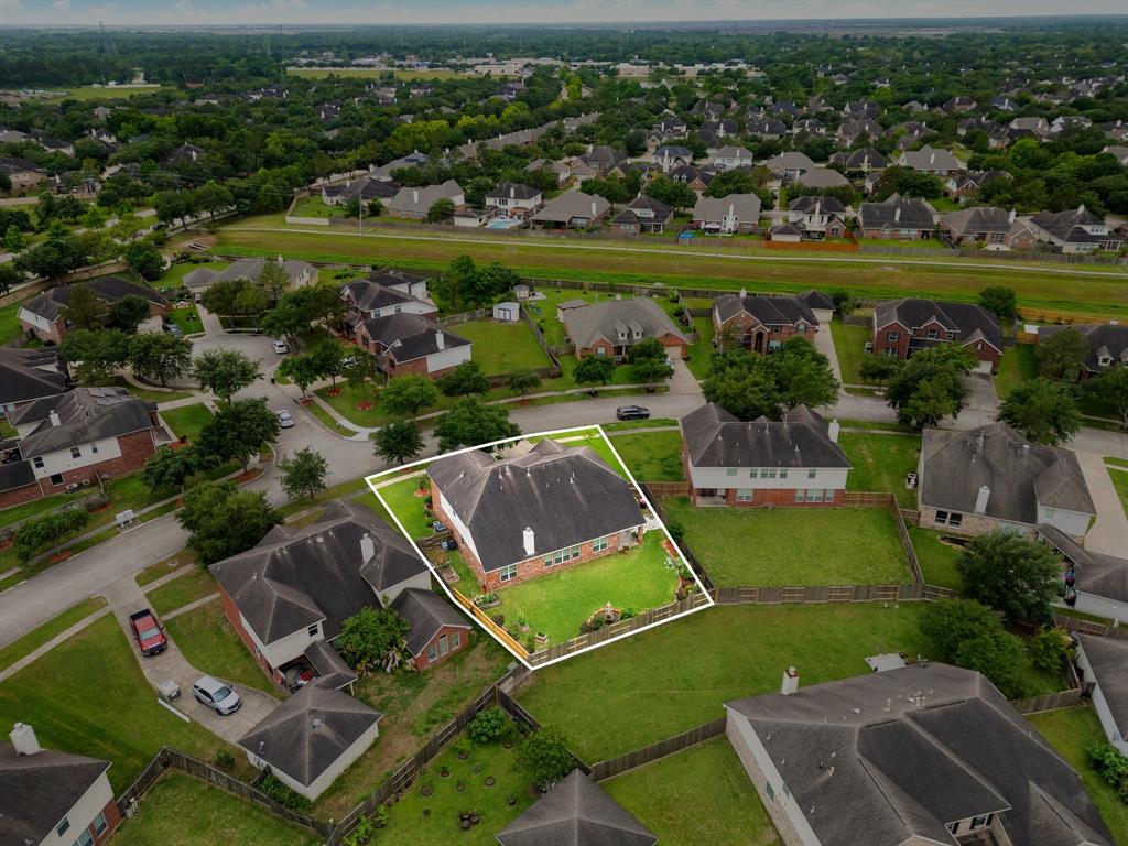 Amazing aerial shot of this home situated on a quiet street in the sought after community of Savannah Landing zoned to Alvin ISD. Lush landscaping, well manicured front lawn and a wonderful back yard perfect to set up an outdoor sitting area.