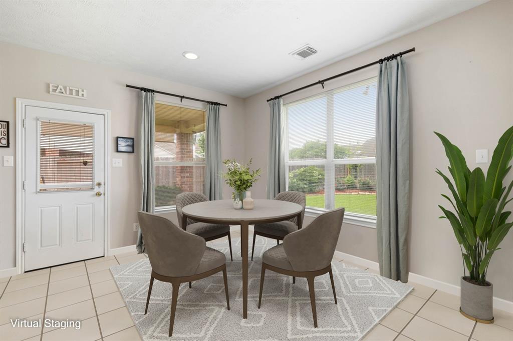 Start your day off right with a cup of coffee sitting with your family in the lovely breakfast area! Featuring large windows with blinds, custom neutral paint, tile flooring and recessed lighting.