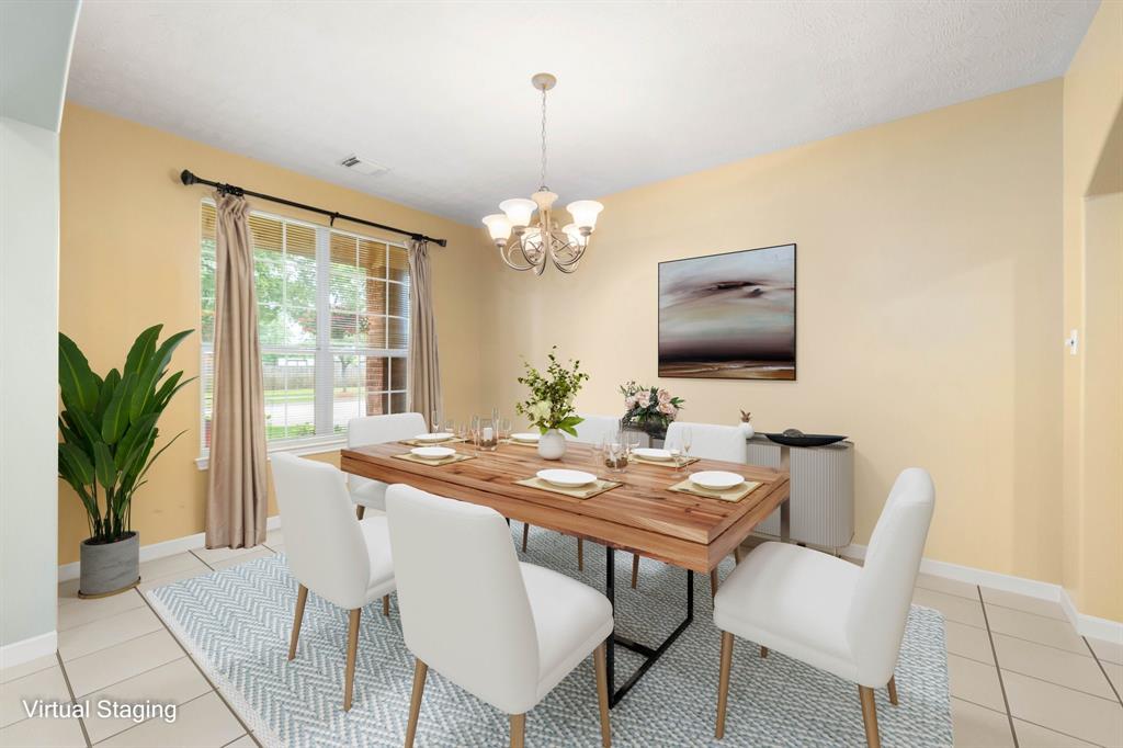 You and your guests will certainly dine in style in this amazing formal dining room! Featuring a gorgeous hanging pendant light, large window with blinds, custom paint and tile flooring. Perfect space to entertain family and friends.