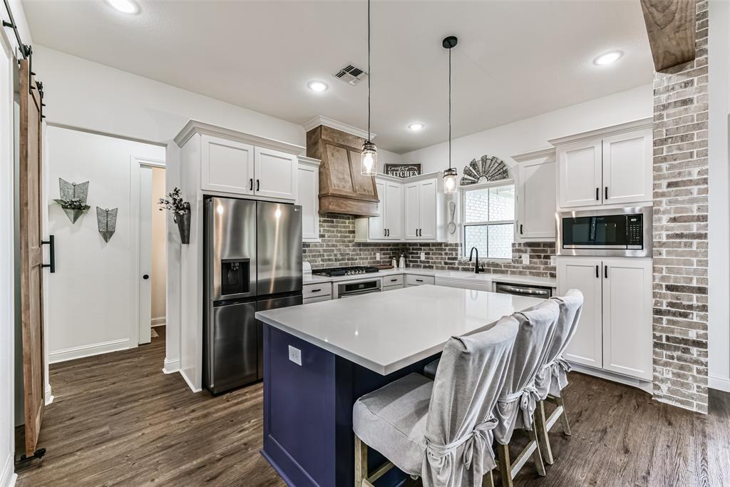 The kitchen is open and bright with plenty of room for cooking and entertaining.