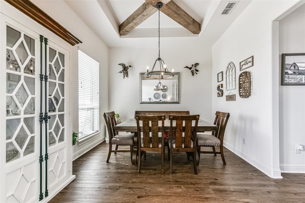 The dining room is stunning with wood cross beams