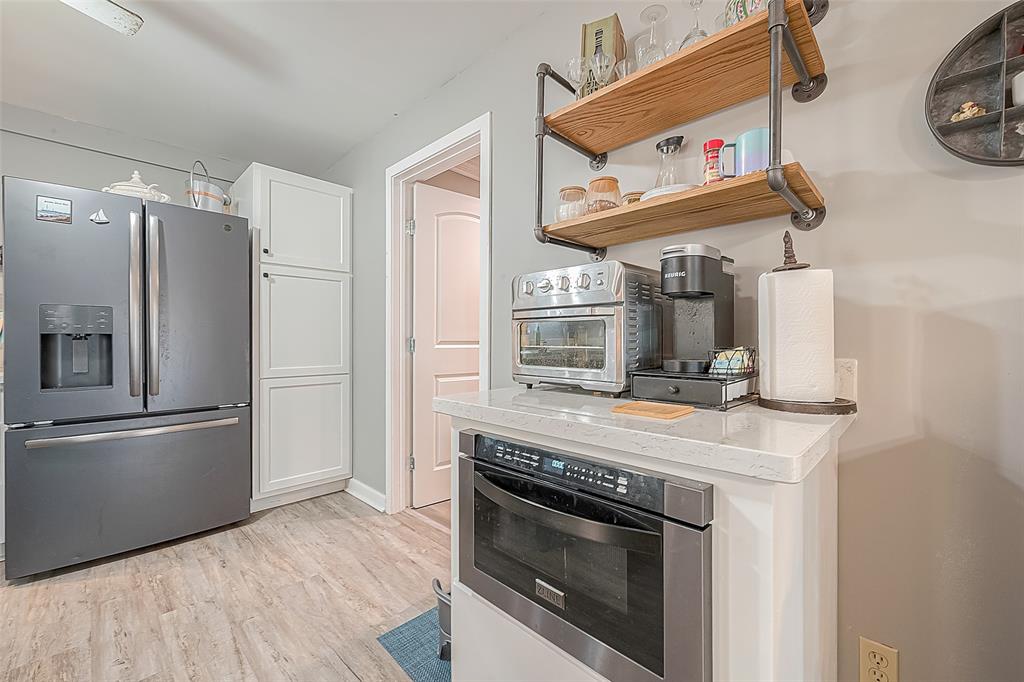 The microwave is built into a cabinet that provides extra storage.