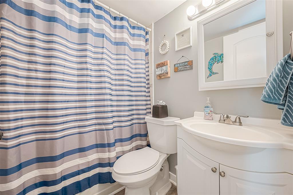 The second bathroom is equipped with a  tub/shower combo, single vanity, and lg mirror/cabinet, offering flexibility and quick showers or relaxing baths.