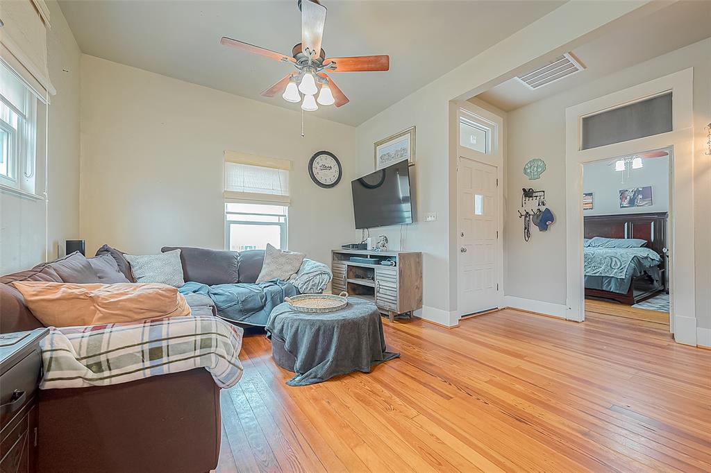 This lovely living room in the upstairs unit features original hardwood floors, several windows for natural lighting and plenty of space.