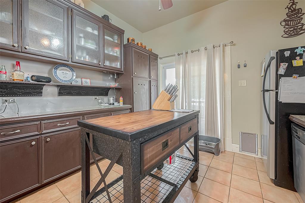 Kitchen features lots of counter and storage space, island block and door to large balcony.