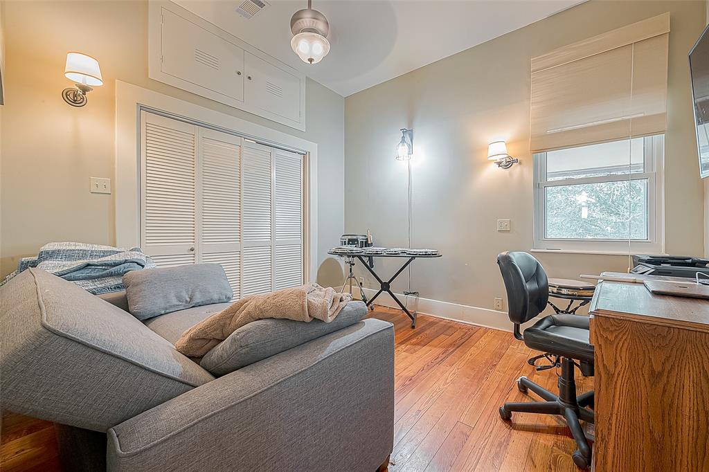 The upstairs secondary bedroom features, sconce lighting, ceiling fan, folding door closet w/storage above and nice backyard views.