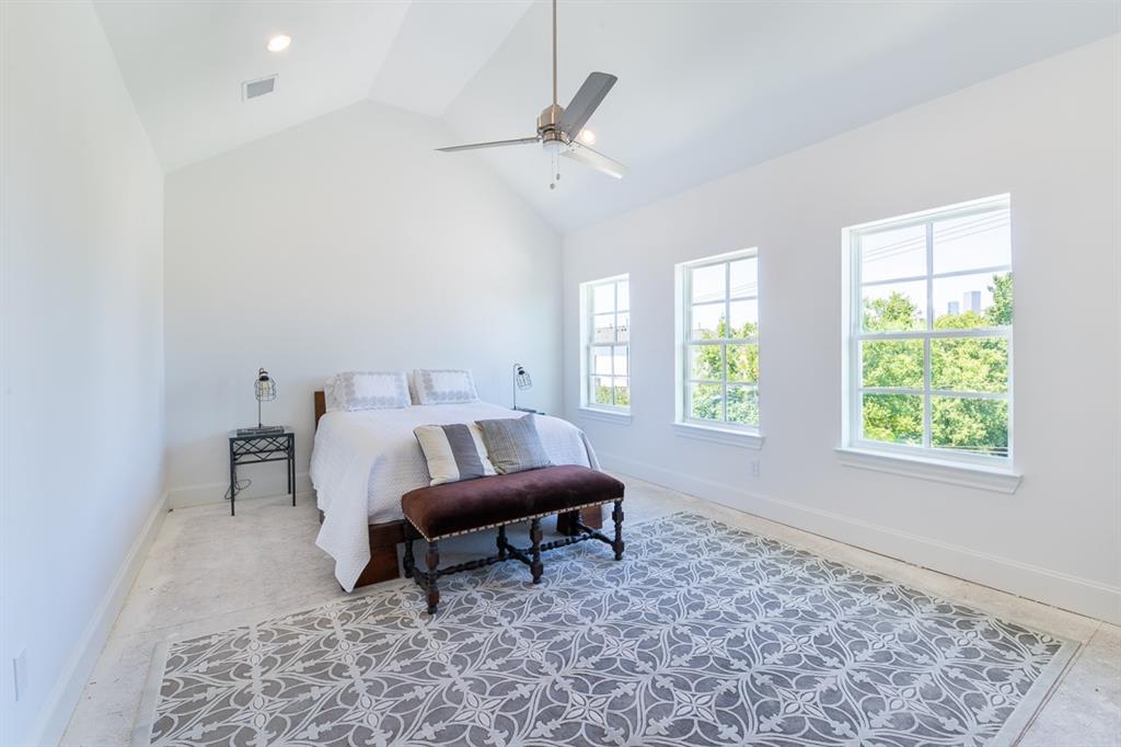 Primary bedroom with tall cathedral ceilings (similar plan and finishes)