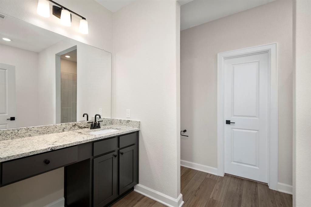 The primary bathroom is a luxurious sanctuary, adorned with elegant fixtures and modern amenities.