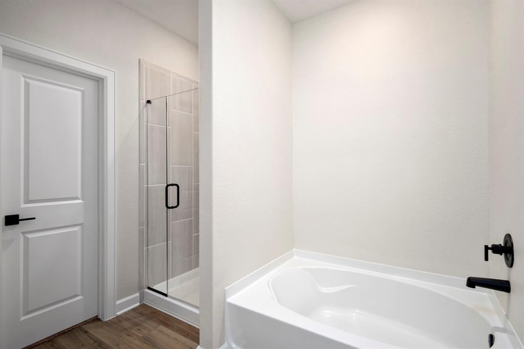 The spacious layout, boast a relaxing soaking tub, a separate walk-in shower, and sleek countertops, creating a tranquil oasis for rejuvenation and pampering.