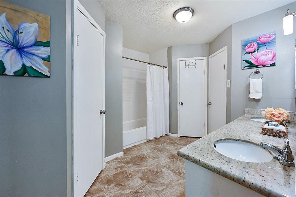 his and hers closets, water closet, and tub/shower combo....