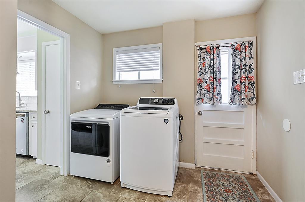 Laundry and cubbies and the powder room are right off the kitchen. That door by the washer and dryer goes out to the garage....