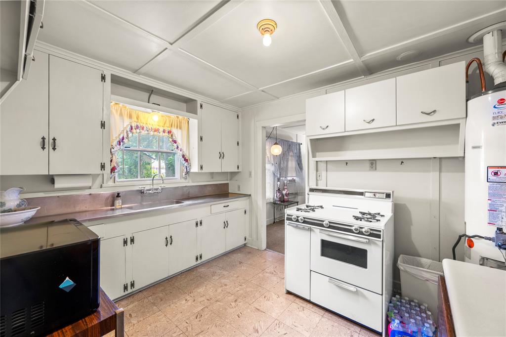 Additional view of kitchen, gas range and hot water heater. East facing window provides lots of natural light.