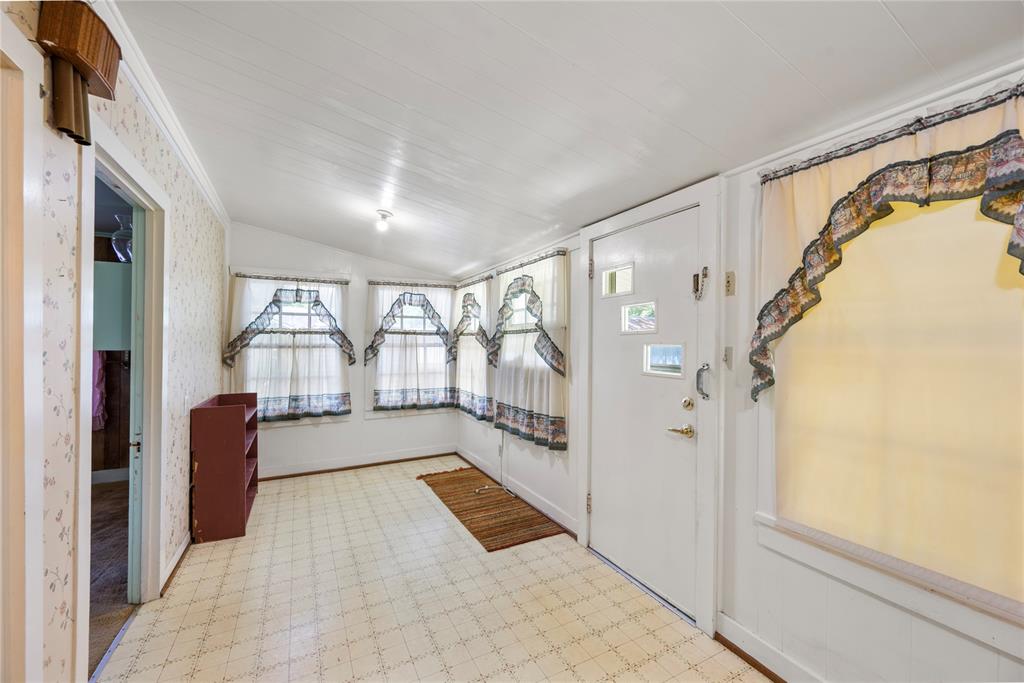 Enclosed back porch runs across the north end of home and has light and views from multiple windows. Washer and dryer connections are located here along with some cabinetry storage.