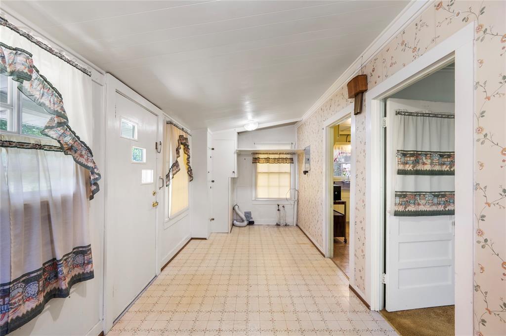 Backyard is accessible from the enclosed porch - washer and dryer connections are seen here at far end of porch with some built in cabinetry.