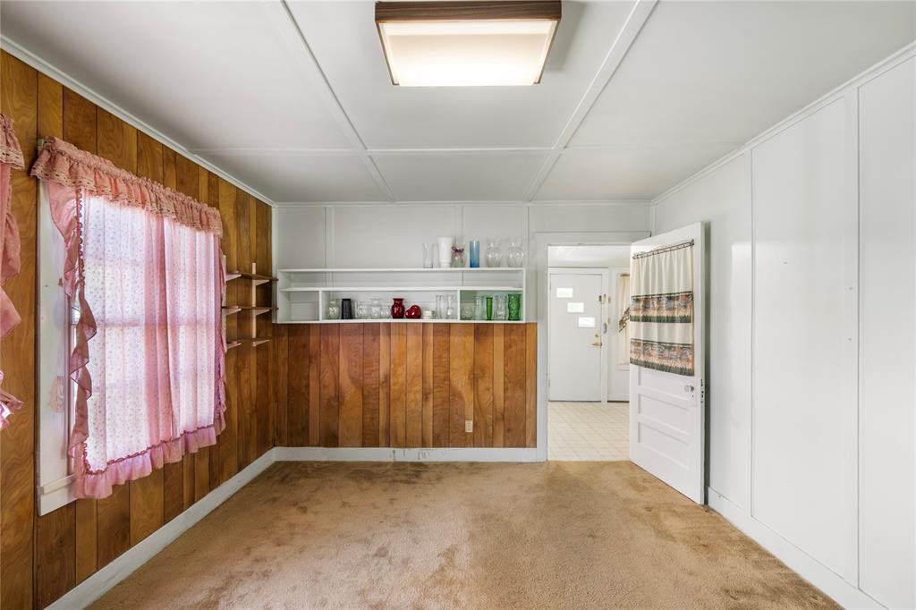 Additional view of bedroom with porch access. These windows look out to driveway.